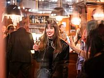 Stadtratspräsidentin Valentina Achermann mit einem Sektglas vor der Bar.