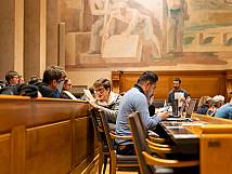 Stadträtin Bernadette Häfliger im Gespräch mit Stadtrat Raffael Joggi; sein Gesicht ist verdeckt durch seinen Laptop.